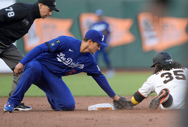 Dodgers shortstop Corey Seager tags a sliding Brandon Crawford of the Giants with the umpire looking over the play
