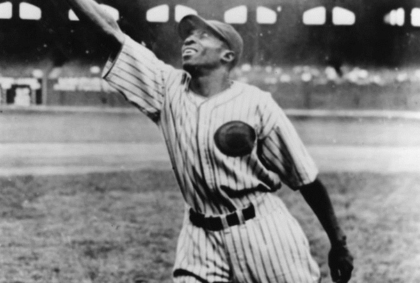 Cool Papa Bell stretching to make a catch with his glove