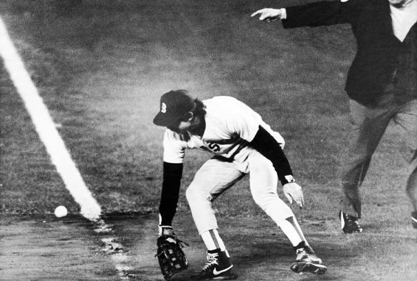 Bill Buckner turns around to see ball that he missed rolling down the first base line from infamous 1986 World Series play