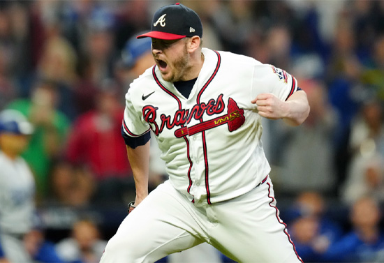 Tyler Matzek fist pumping in celebration at the pitcher's mound in white Braves uniform