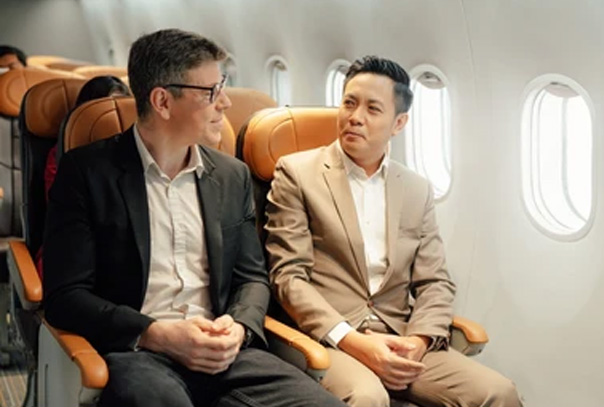 Two business men sitting on a plane