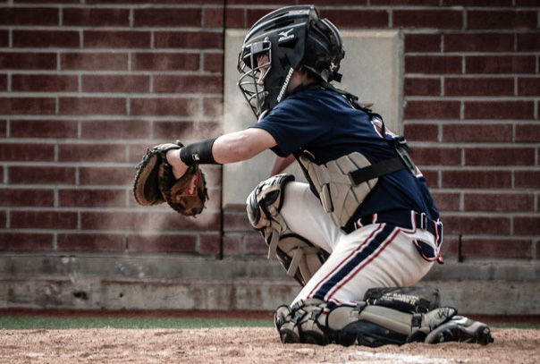 Youth catcher on one knee