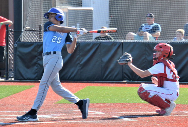 A travel ball player at bat.