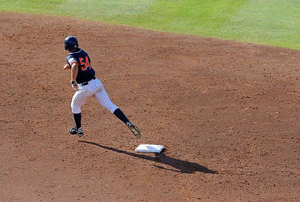 A baserunner rounding second base from an aerial view